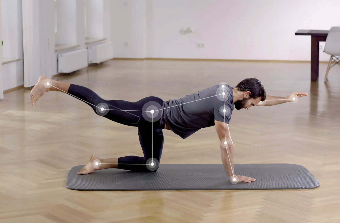 Young man doing yoga on a mat in his room