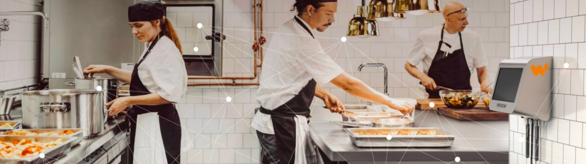 Three chefs in the restaurant kitchen preparing food